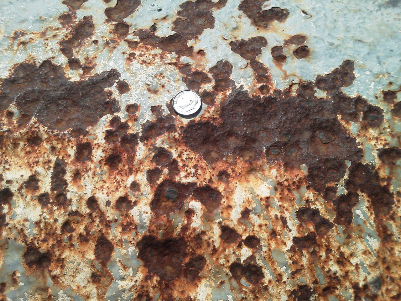 Close-up of heavy corrosion and pitting to one of the pipes