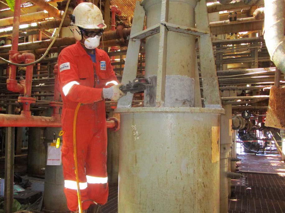 Engineer prepares surface with power tools in readiness for application