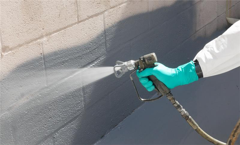 Belzona 5815 being brushed onto a concrete containment area