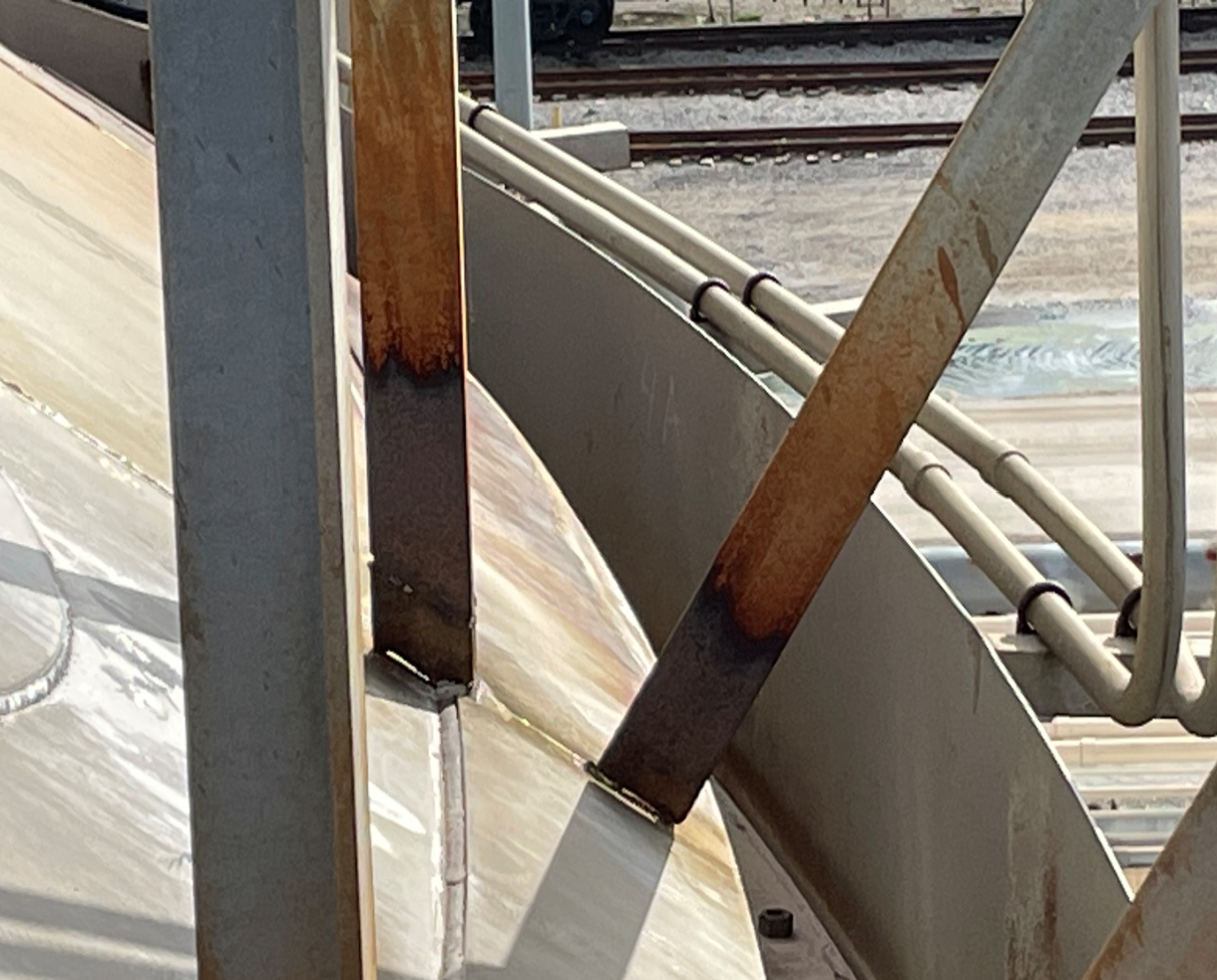 During inspection of the N4 Nitric Acid Storage Tank, Customer discovered that several welds attaching the roof access stair support brackets to the tank roof had separated. These brackets are critical for supporting the stairway used to access the top of the tank for inspection and maintenance activities.