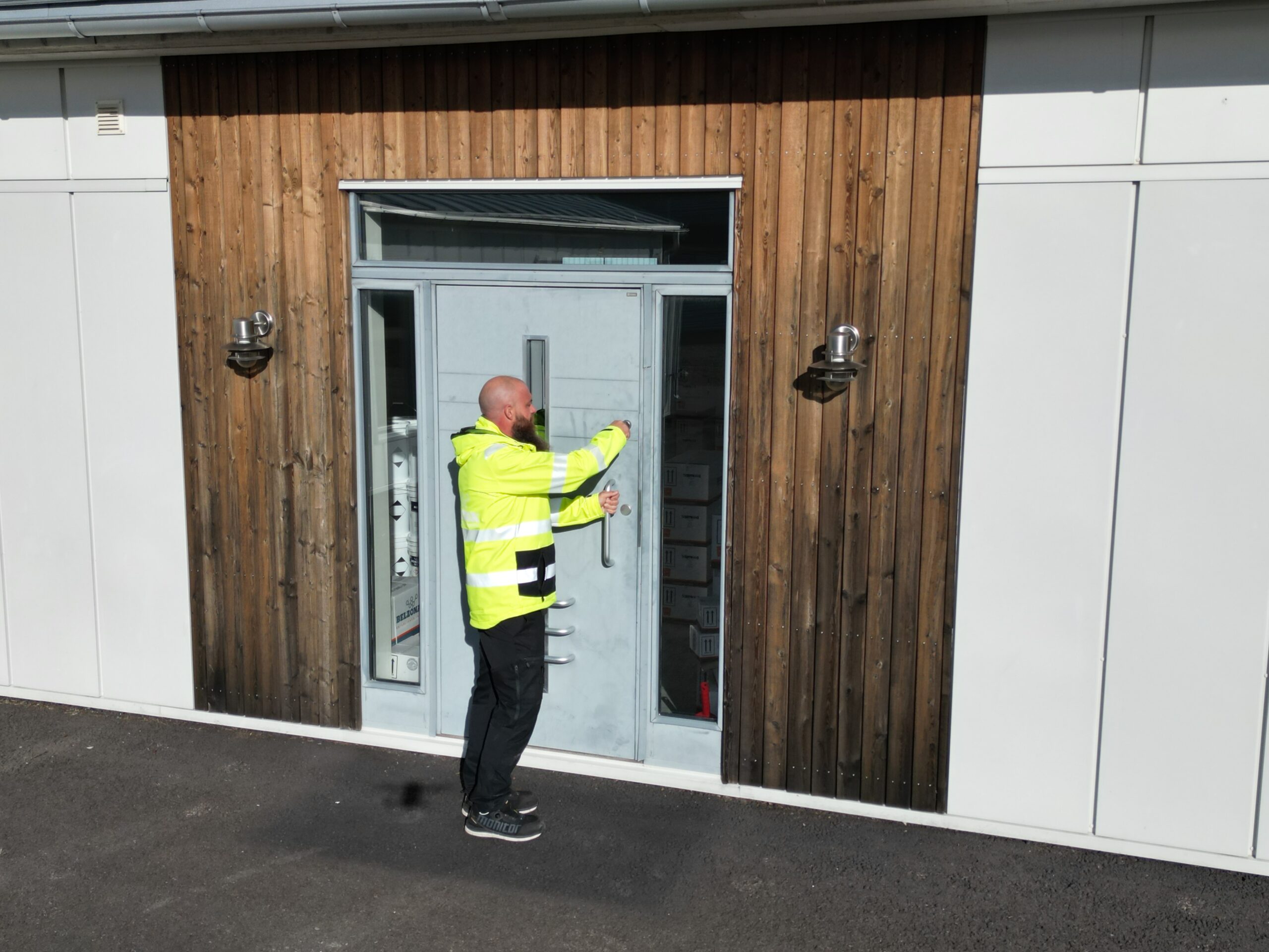 Niklas Blom unlocking door of new Swedish Distributor Headquarters