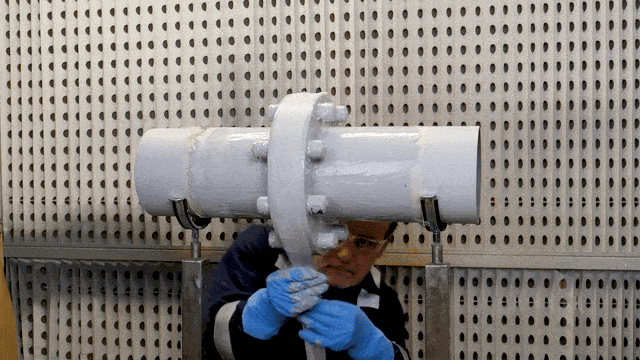 Applying Belzona 9311 (Reinforcement Sheet) around the flange circumference.