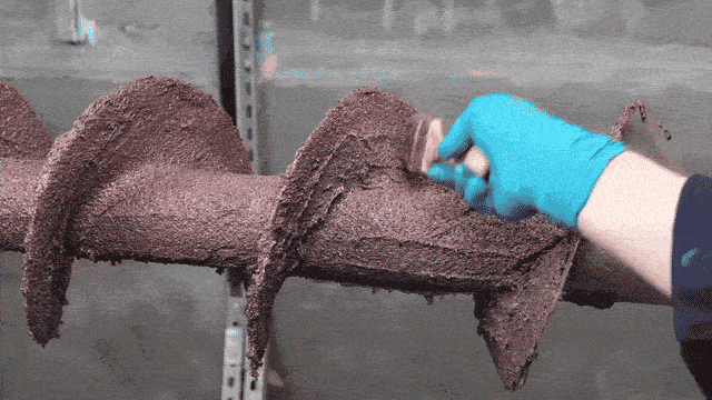 Contouring the abrasion resistant coating with a short-bristled brush to eliminate air pockets and create an even profile.