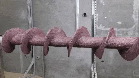 Freshly coated screw conveyor after application of Belzona 1811 (Ceramic Carbide) during the curing stage.