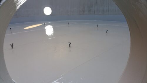 A steel tank floor is coated to prevent corrosion